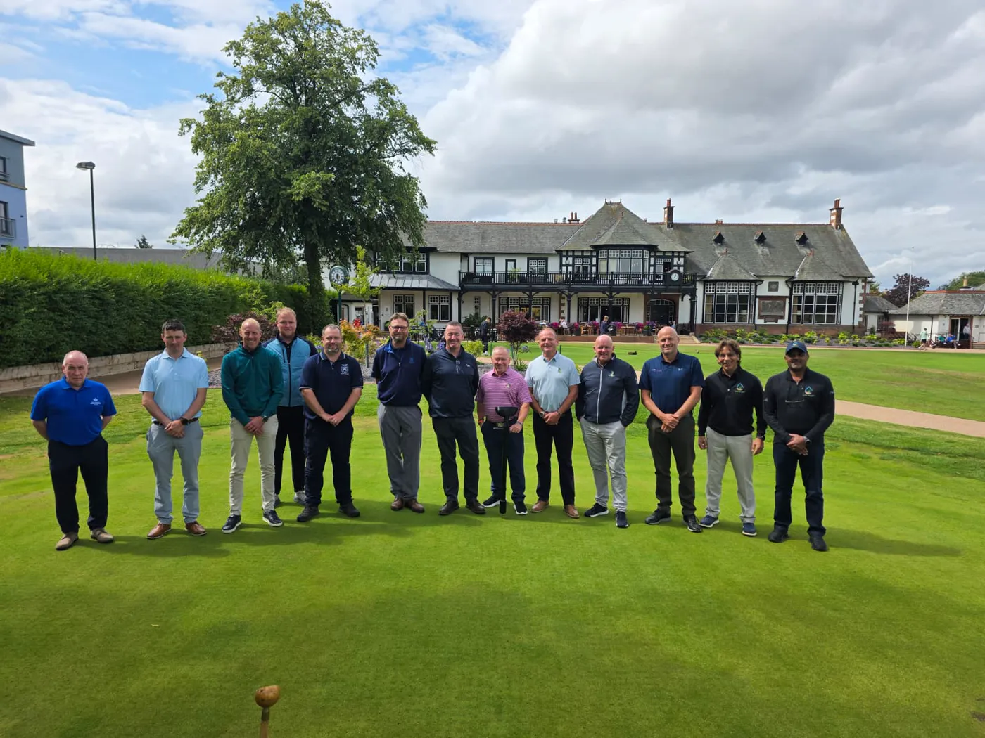 Turf professionals gathered on a putting green during a PURE Insight education session