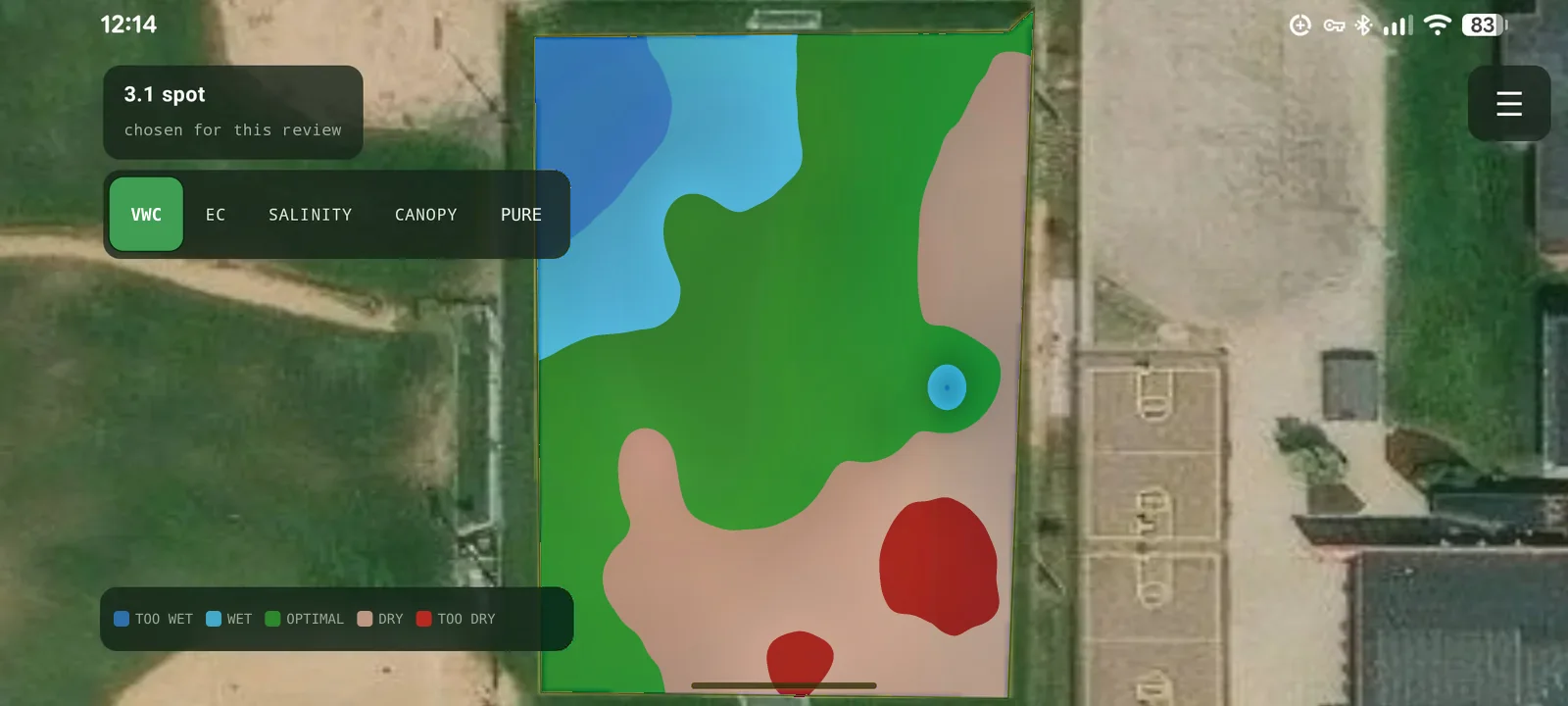 The analysis screen: the same area shaded as a moisture map, blue where the turf is too wet grading through green where it is optimal to tan and red where it is too dry, a row of variable toggles reading VWC, EC, SALINITY, CANOPY and PURE with VWC selected, and a legend running TOO WET, WET, OPTIMAL, DRY, TOO DRY